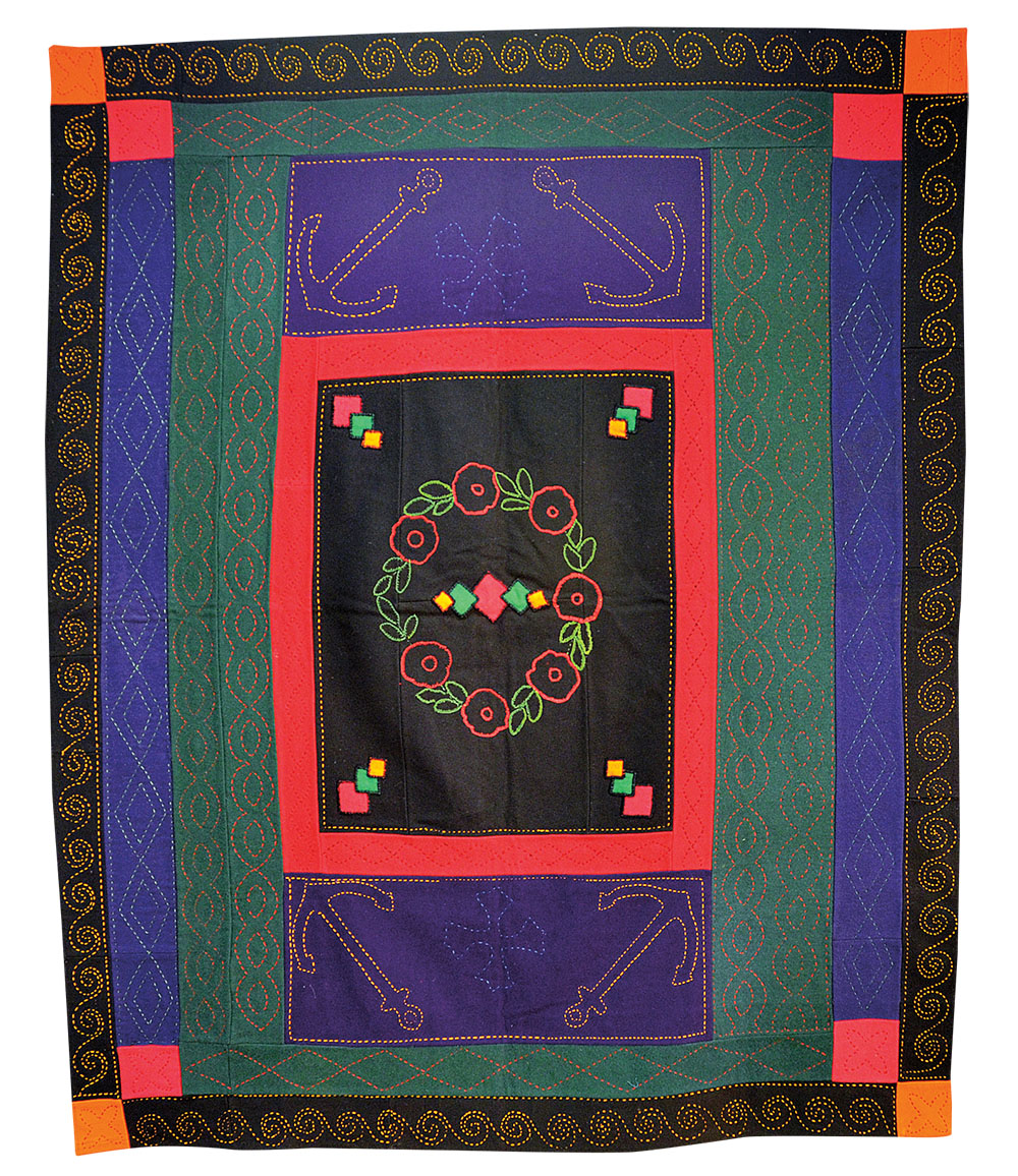 “Rose Wreath Center Medallion Framed Rectangle” • Irish • Wool • 69" x 75" • Early twentieth century • The back of this quilt is red cotton sateen. Minus the specific quilting patterns and embroidery, typical of Irish quilts, the basic design influence of Amish quilts is obvious. It is not known if this quilt was made in this country or brought here from Ireland.